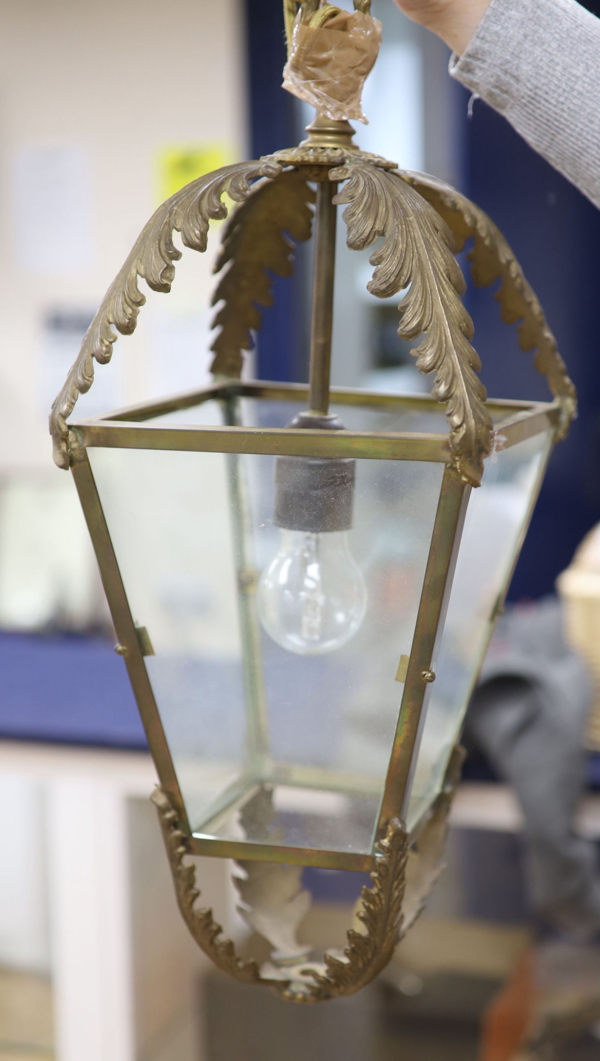 A metal framed ceiling lantern and a three branch cherub and lustre hung ceiling pendant (2)